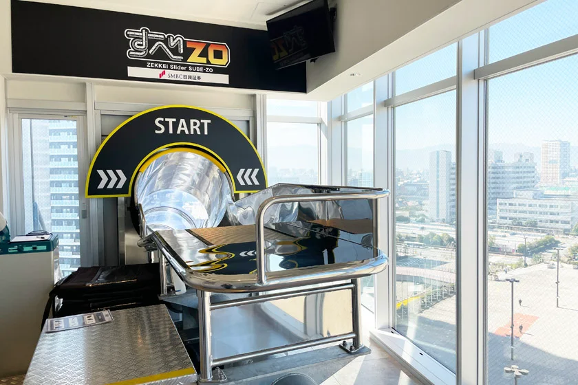 The sube-ZO start area at BOSS E・ZO FUKUOKA: check-in, lockers and safety preparation happen before the short descent.