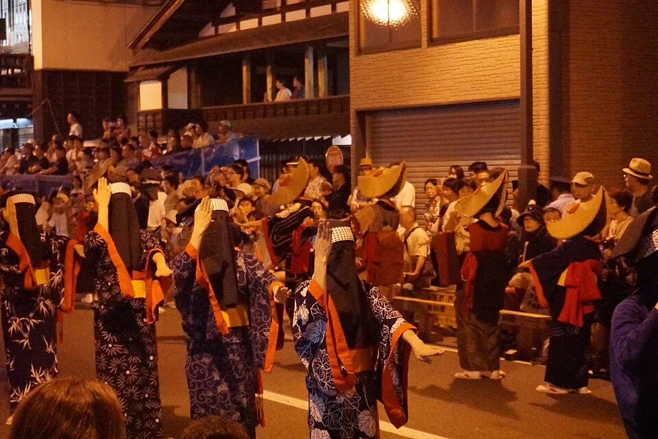 Nishimonai Bon Odori dancers lining Honmachi Street at night in Ugo, Akita