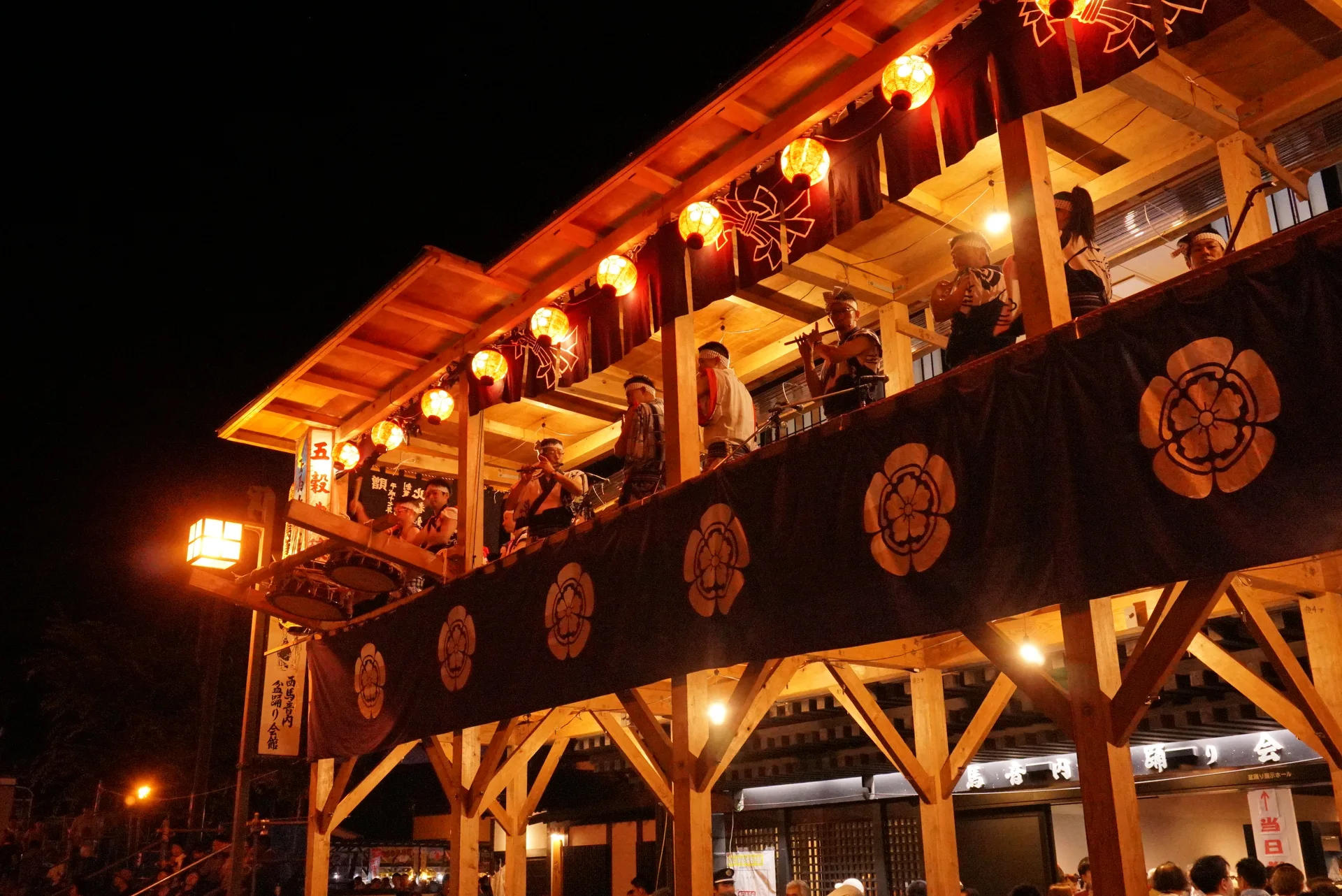 Festival musicians performing above Honmachi Street during Nishimonai Bon Odori