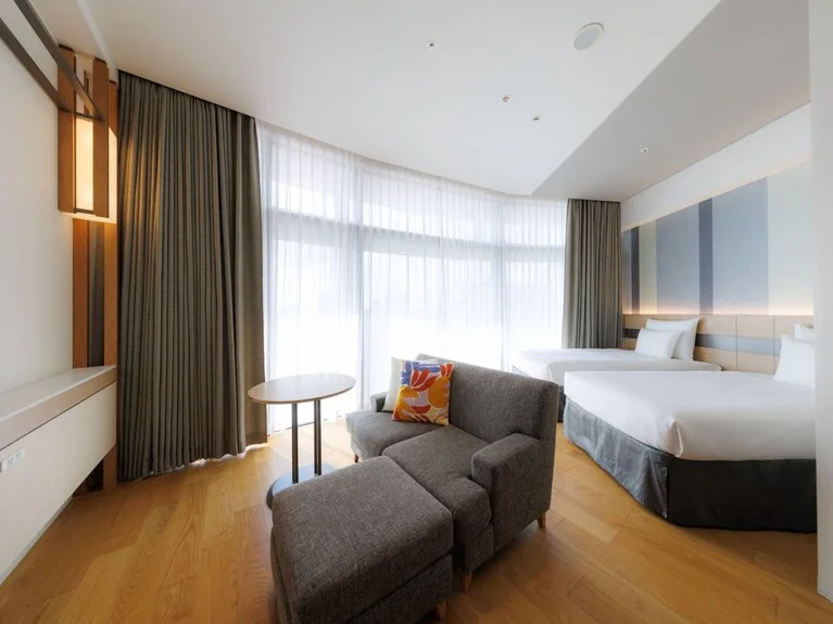 JR Kyushu Hotel Blossom Naha room for a multigenerational family comparing bathroom and bedtime logistics