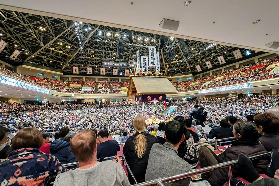 Grand sumo wrestlers competing on the dohyo inside Ryogoku Kokugikan in Tokyo