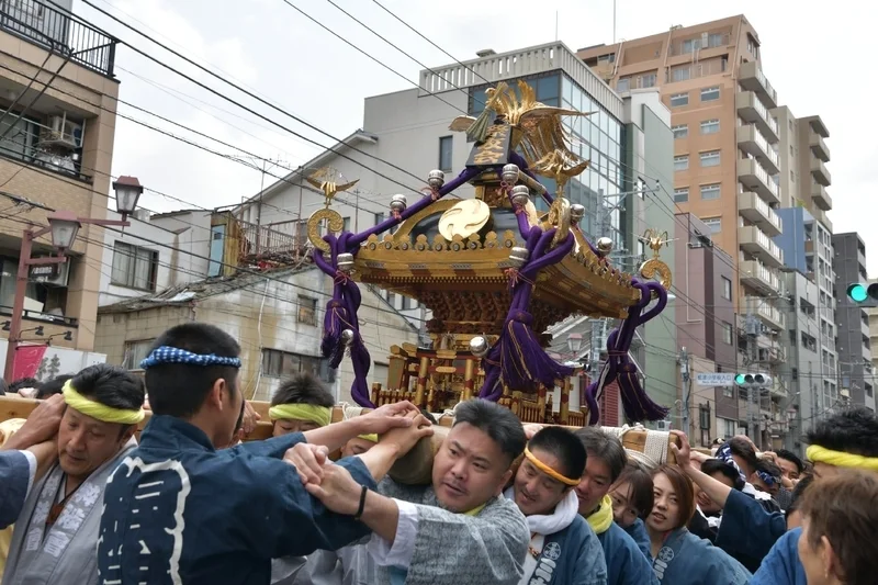 Nezu Shrine mikoshi procession moving through the Yanesen neighborhood streets in Tokyo