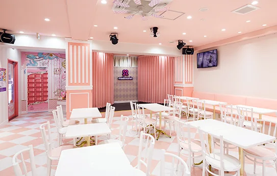 Inside Maidreamin Fukuoka Tenjin Nishi-dori: seating and the participatory maid-cafe atmosphere that separates the experience from an ordinary coffee stop.