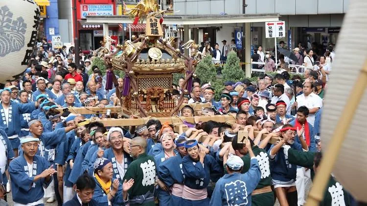 Close view of mikoshi bearers during Fukuro Matsuri near Ikebukuro Station West Exit