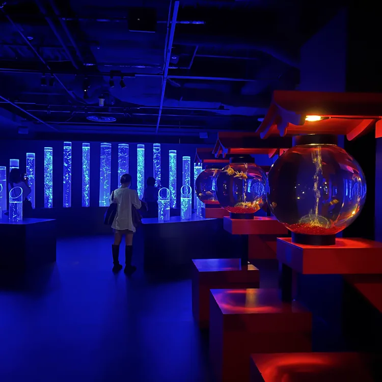 Blue-lit sculptural goldfish aquarium installation at Art Aquarium Museum GINZA