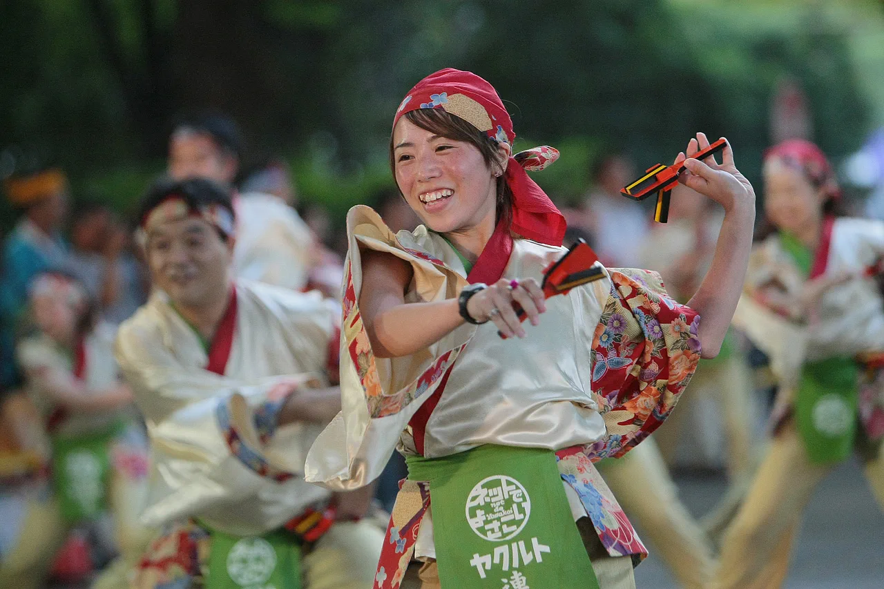 A large Super Yosakoi dance team performing in formation on a Harajuku street