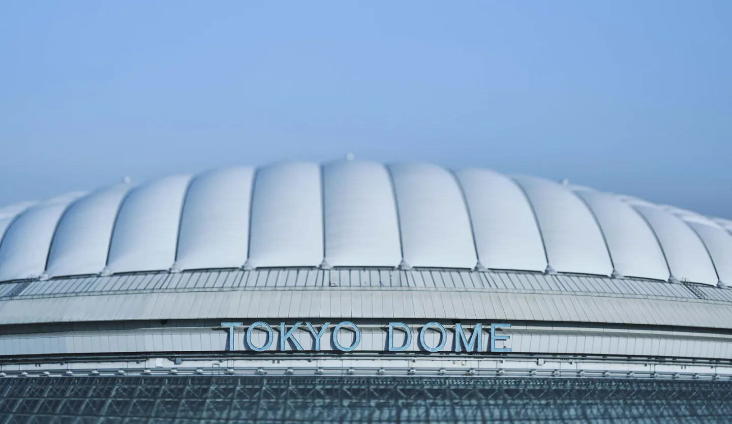 Tokyo Dome exterior beneath a clear blue sky