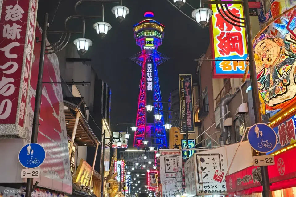 Osaka Shinsekai Food Tour 2026 at night beneath the neon restaurant signs